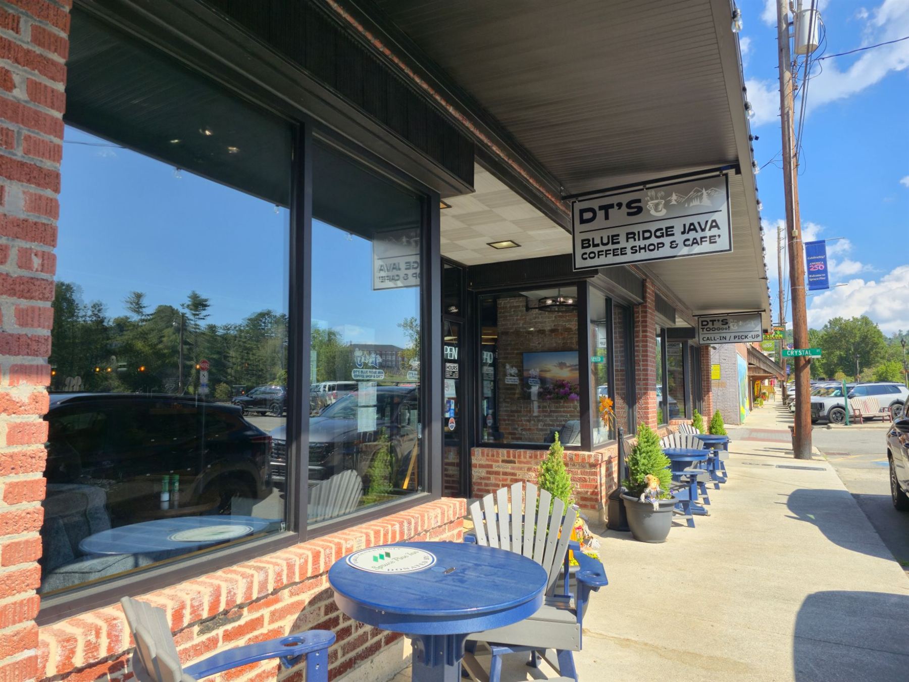 DT's storefront on Locust Street, with blue patio tables along the brick sidewalk